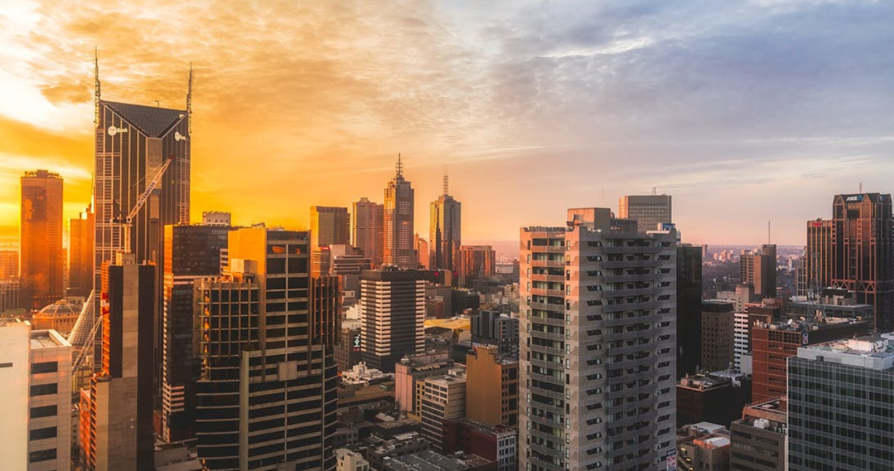 City skyline at sunset showing urban buildings affected by climate change